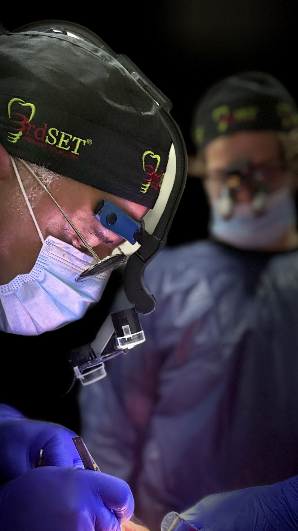 3rdSET surgeon placing dental implants while wearing surgical loupes